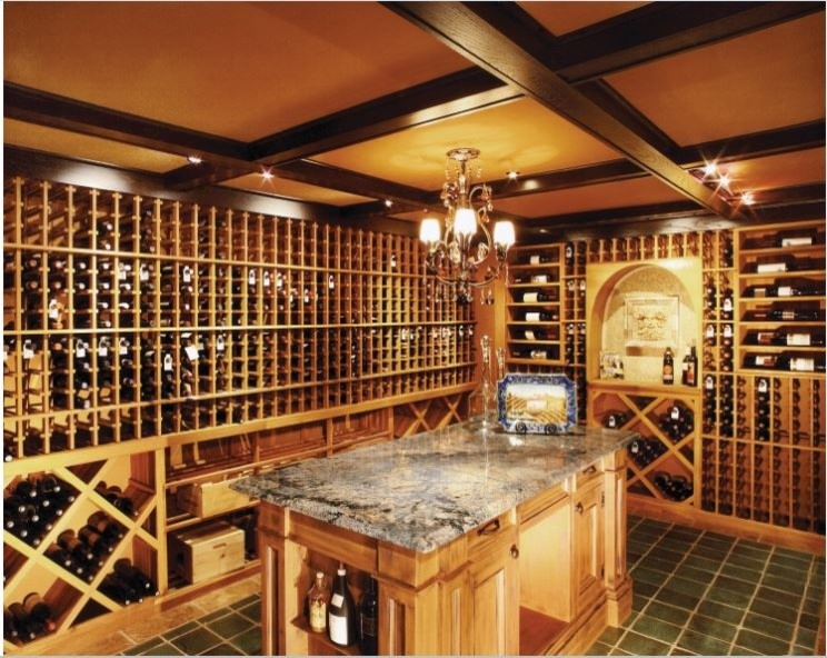 Large elegant ceramic tile wine cellar photo in Orange County with storage racks