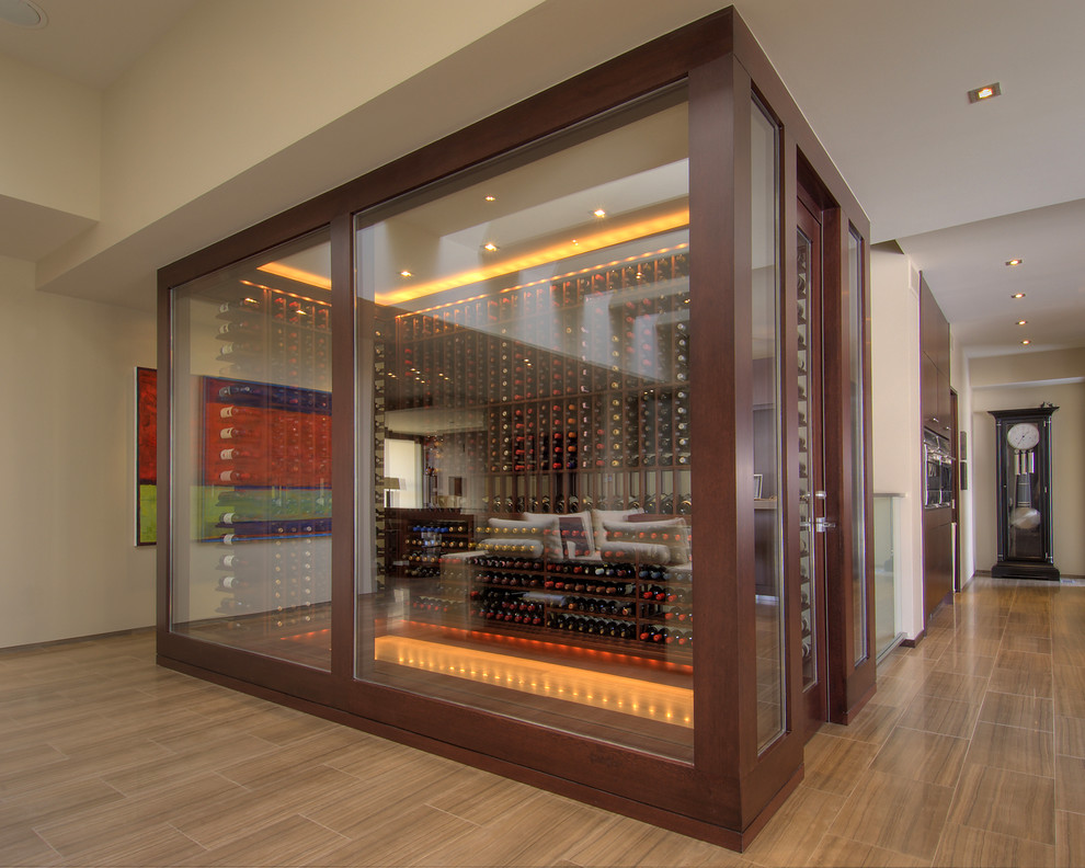 Medium sized contemporary wine cellar in Toronto with porcelain flooring, storage racks and brown floors.