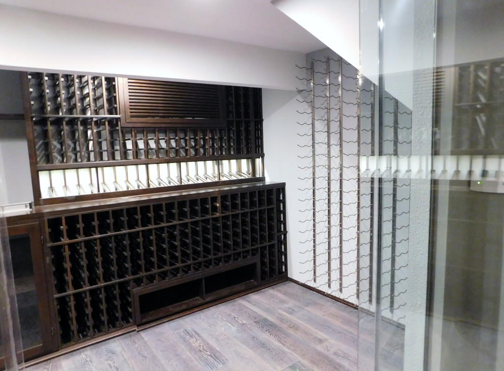 Example of a mid-sized transitional wine cellar design in Orange County with storage racks