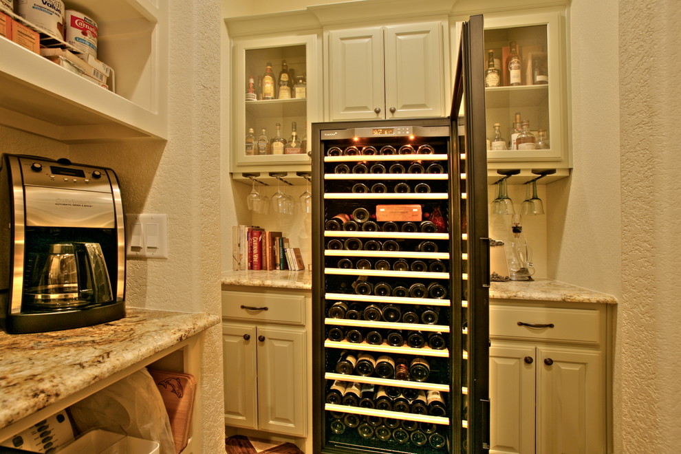 Photo of a medium sized traditional wine cellar in Dallas with medium hardwood flooring and cube storage.