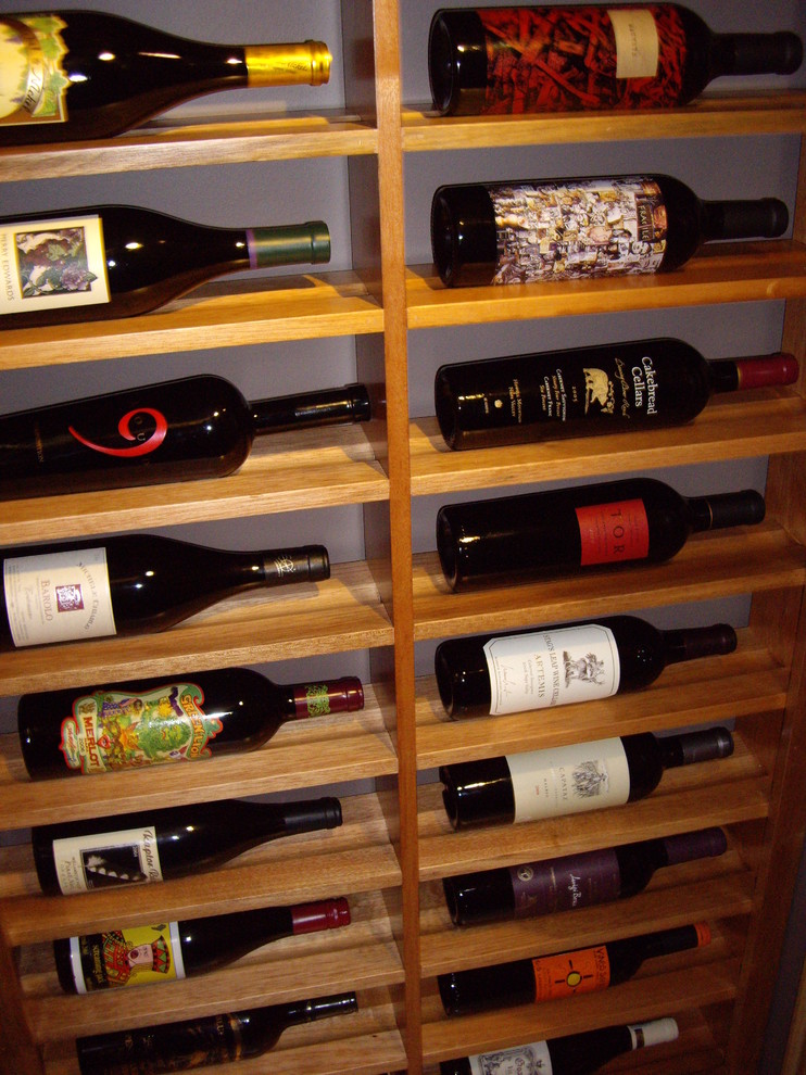Example of a mid-sized classic wine cellar design in Dallas with storage racks