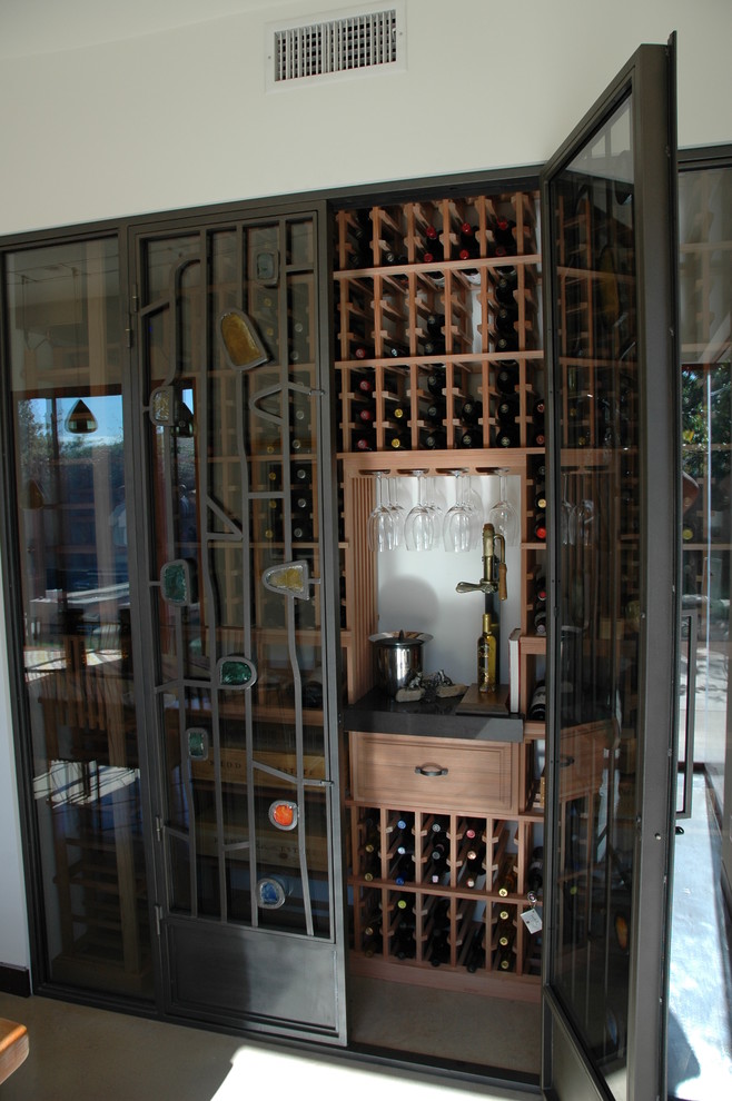 Inspiration for a small rustic wine cellar in Orange County with storage racks.