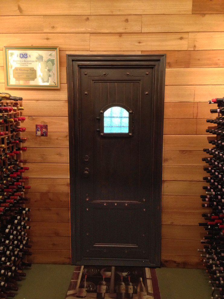 Mid-sized tuscan wine cellar photo in Other with storage racks