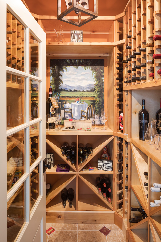 This is an example of a country wine cellar in Chicago with cube storage and brown floors.