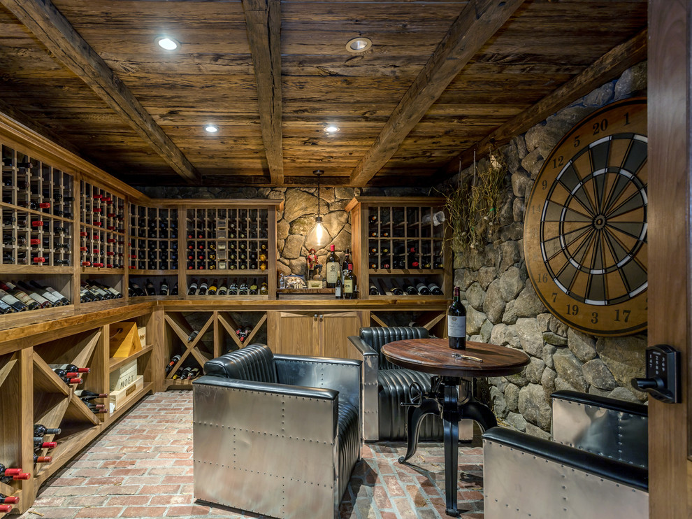 Photo of a rustic wine cellar in New York with brick flooring, storage racks and red floors.