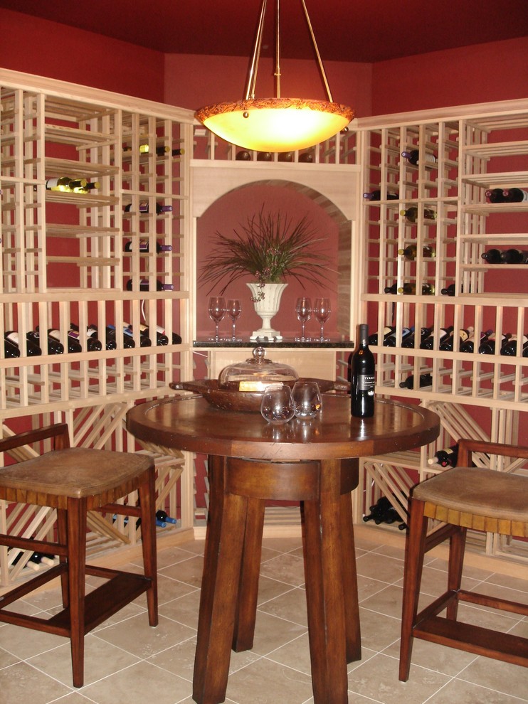 This is an example of a large traditional wine cellar in Other with storage racks and porcelain flooring.