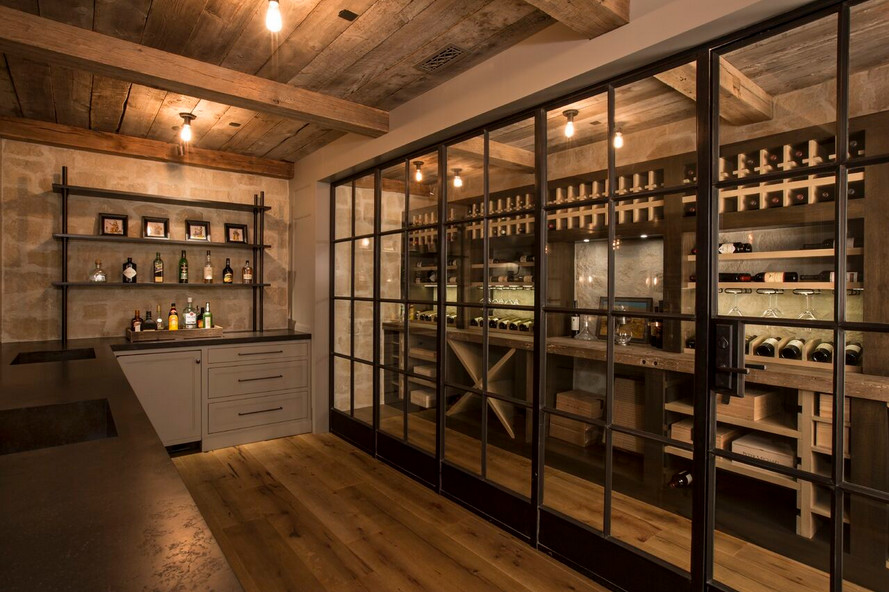 Inspiration for a mid-sized mediterranean medium tone wood floor wine cellar remodel in Orange County with storage racks