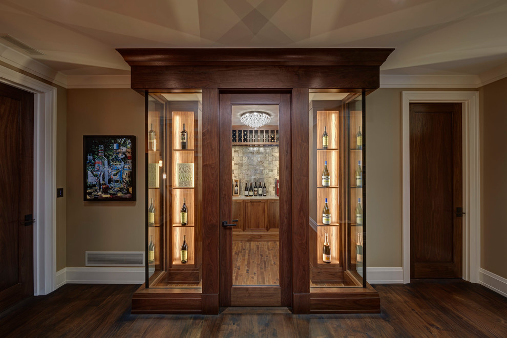 Inspiration for a transitional medium tone wood floor and brown floor wine cellar remodel in Other with display racks