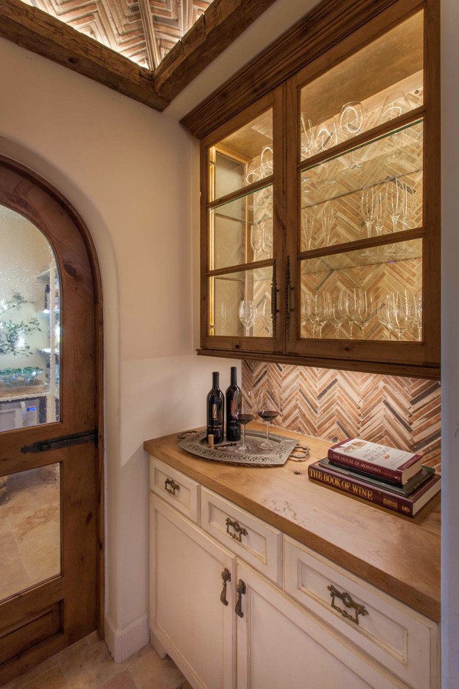 Inspiration for a medium sized mediterranean wine cellar in San Diego with limestone flooring and beige floors.
