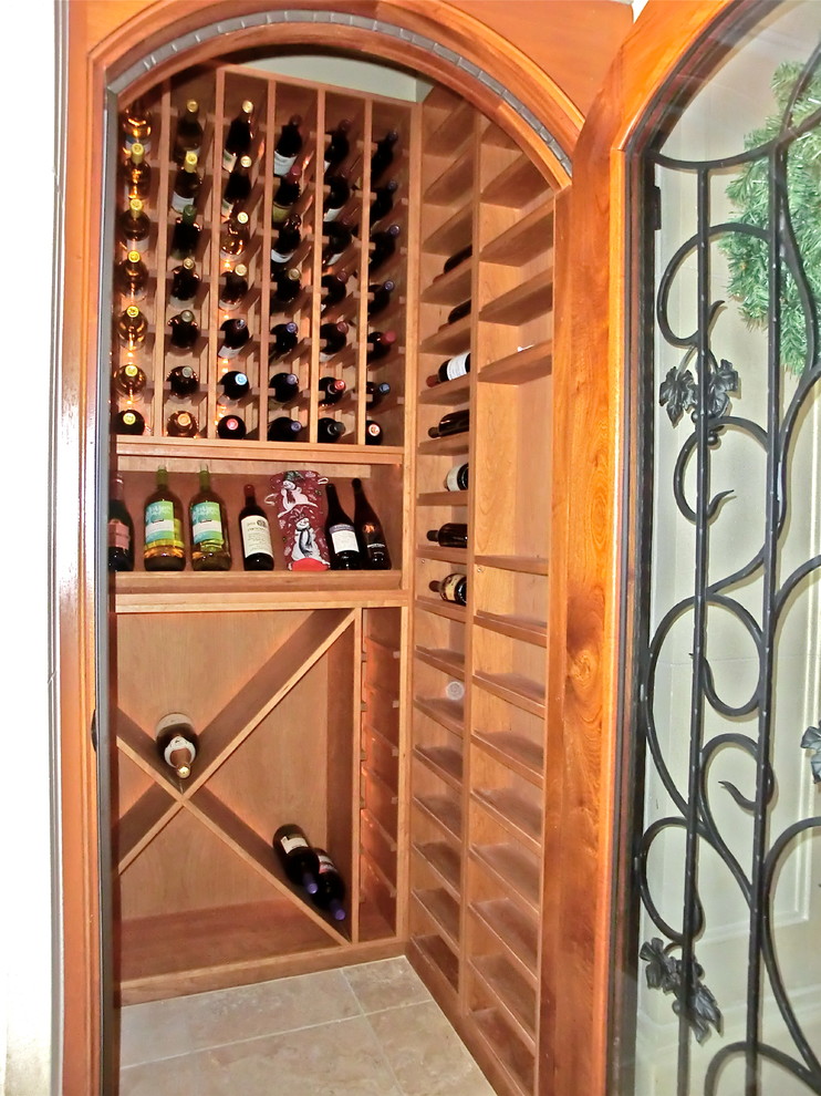Photo of a medium sized mediterranean wine cellar in San Luis Obispo with travertine flooring and cube storage.