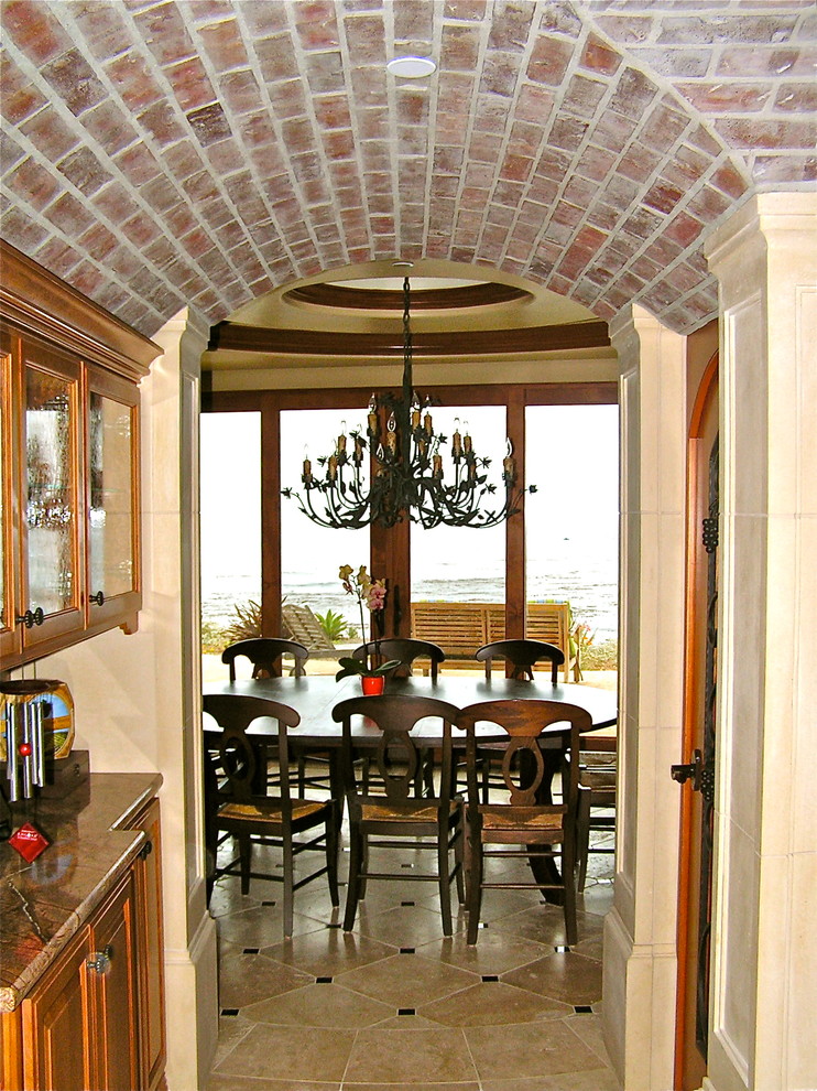 Mid-sized tuscan travertine floor wine cellar photo in San Luis Obispo with diamond bins
