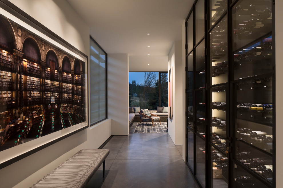 Inspiration for a large rustic concrete floor and gray floor wine cellar remodel in Other with display racks