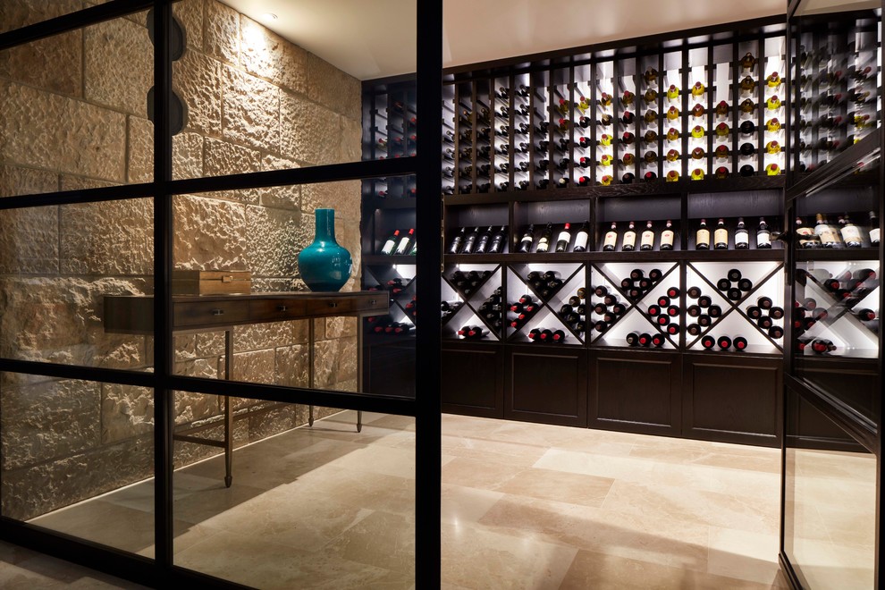Photo of a traditional wine cellar in Sydney with display racks and beige floors.