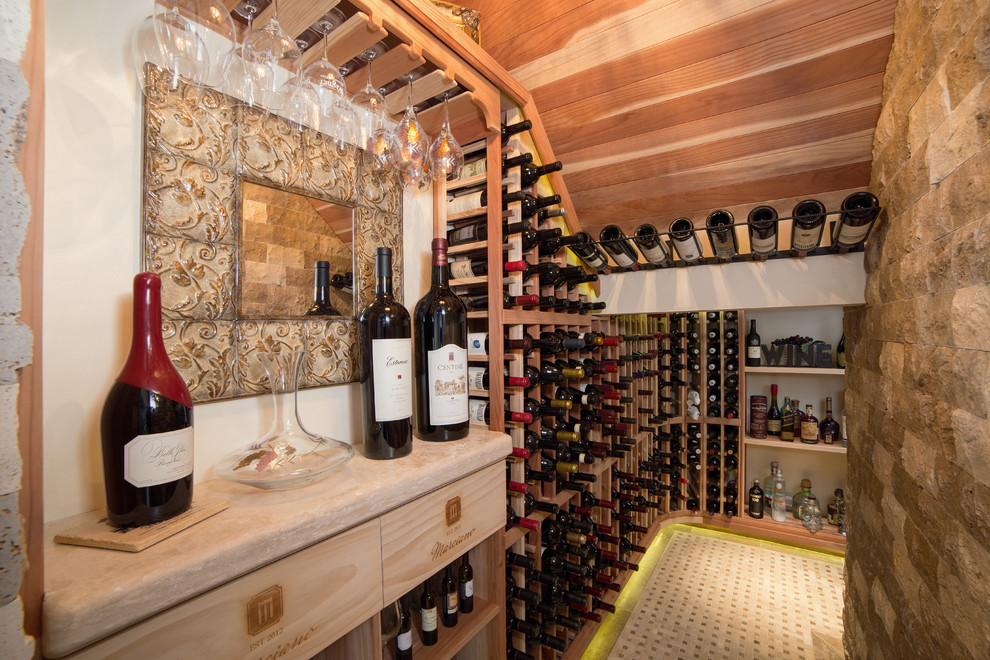 Mid-sized tuscan travertine floor wine cellar photo in Phoenix with storage racks