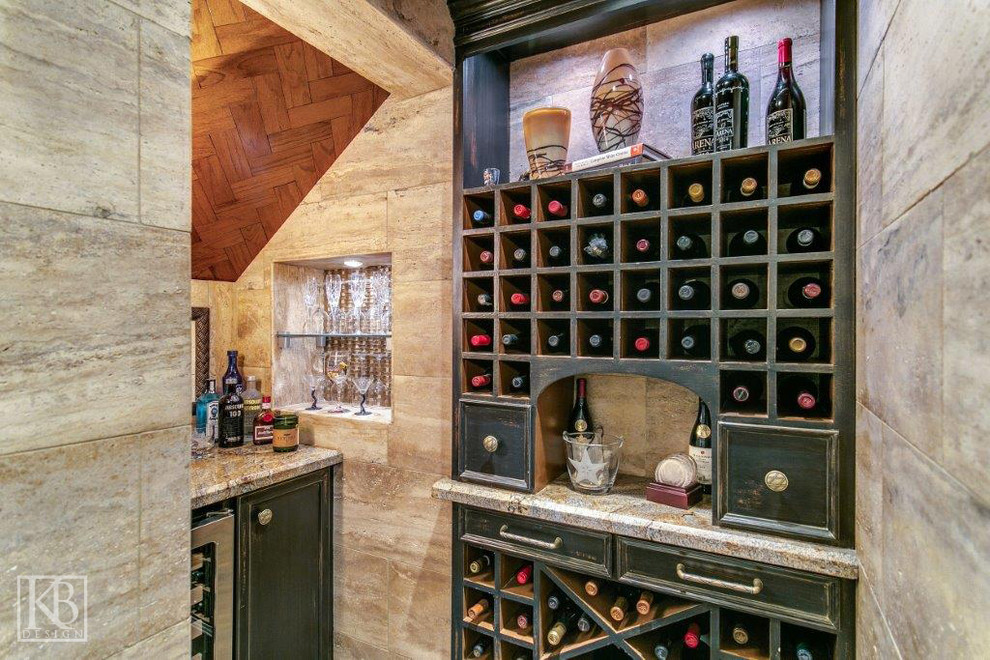 Inspiration for a small wine cellar remodel in Houston with display racks