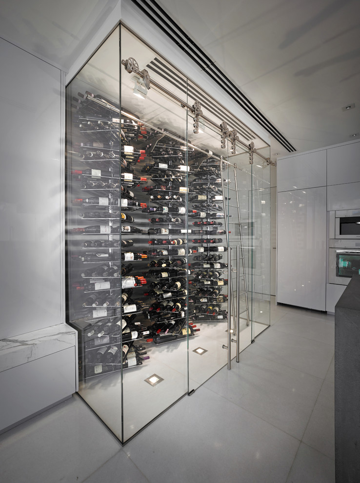 Example of a minimalist wine cellar design in Miami with display racks