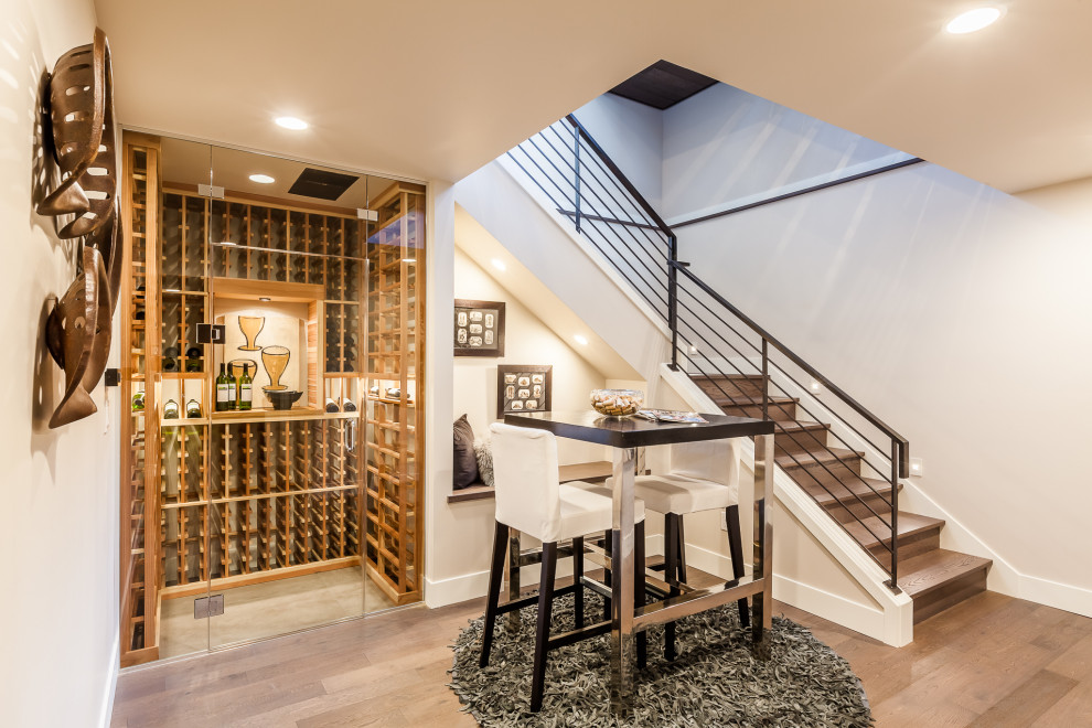 Inspiration for a large contemporary medium tone wood floor and brown floor wine cellar remodel in Seattle with storage racks