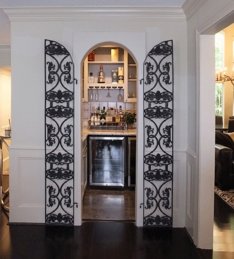 Inspiration for a small eclectic limestone floor wine cellar remodel in Houston with display racks