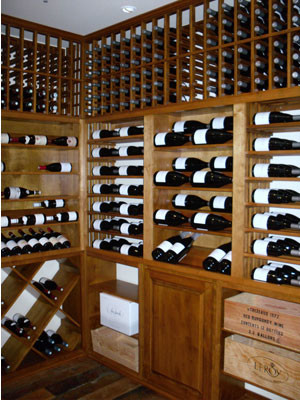 Inspiration for a mid-sized timeless medium tone wood floor wine cellar remodel in Santa Barbara with storage racks