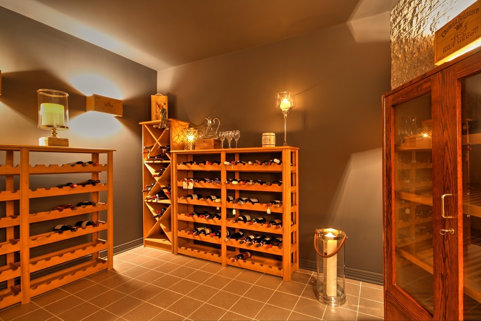 Wine cellar - mid-sized traditional ceramic tile wine cellar idea in Montreal with diamond bins