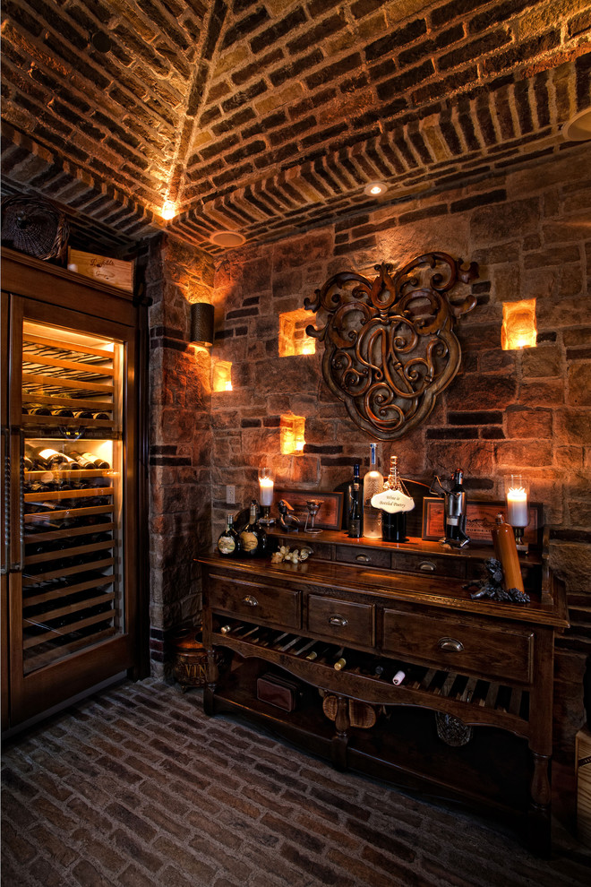 Inspiration for a mediterranean brick floor and black floor wine cellar remodel in Orange County