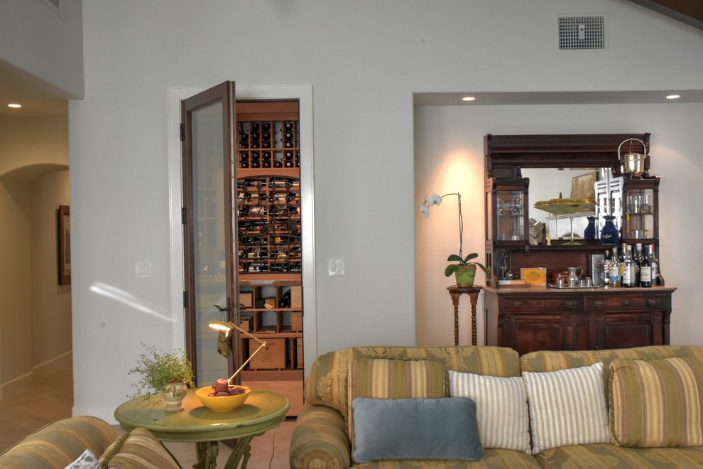 This is an example of a medium sized country wine cellar in Orange County with ceramic flooring, display racks and beige floors.