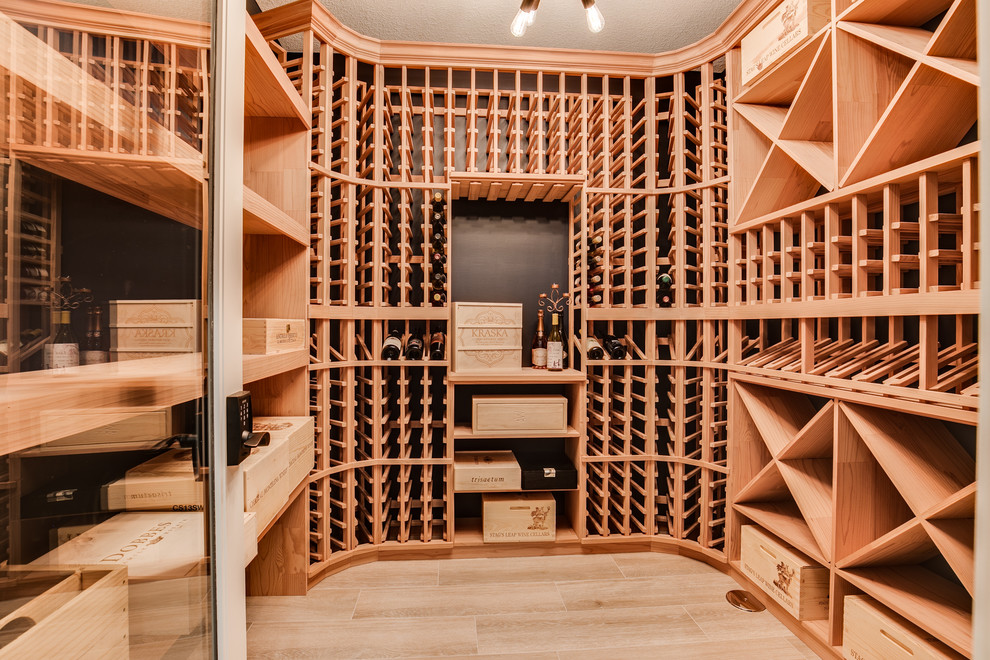 Inspiration for an expansive farmhouse wine cellar in Minneapolis with light hardwood flooring, storage racks and beige floors.
