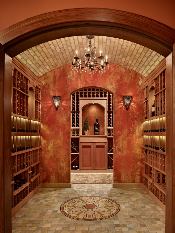 Example of a mid-sized tuscan terra-cotta tile wine cellar design in Seattle with display racks