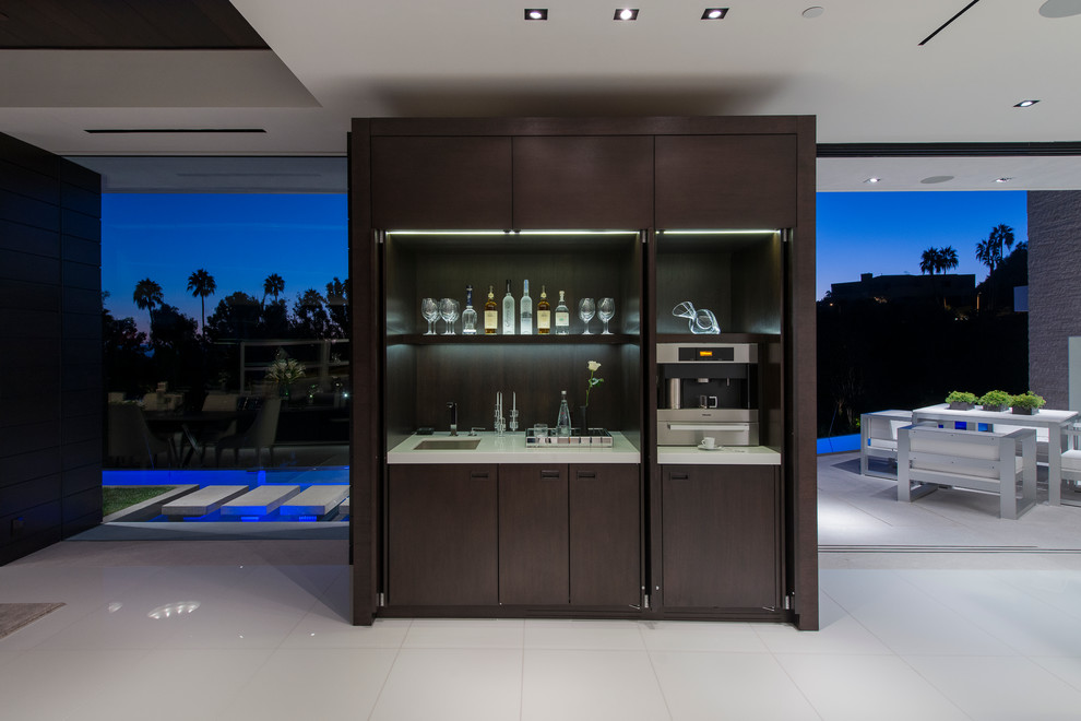 Photo of an expansive modern wine cellar in Los Angeles with display racks, white floors and feature lighting.