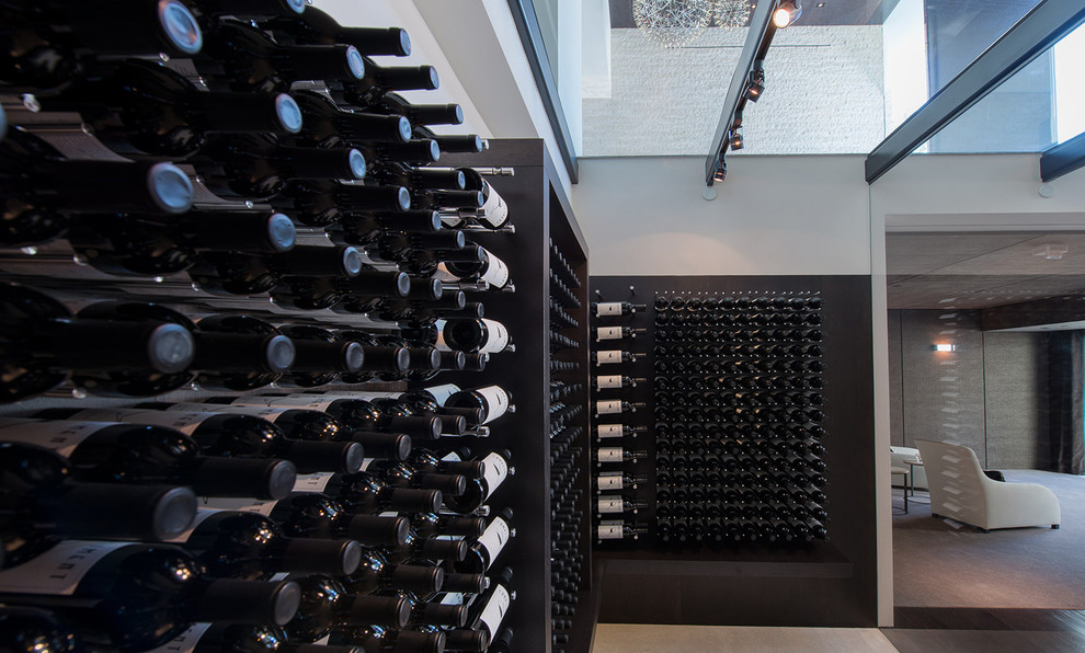 Design ideas for an expansive modern wine cellar in Los Angeles with storage racks, white floors and feature lighting.