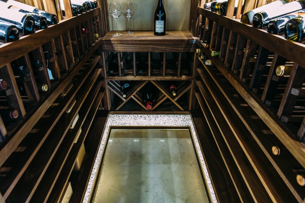Small transitional marble floor wine cellar photo in Los Angeles with storage racks