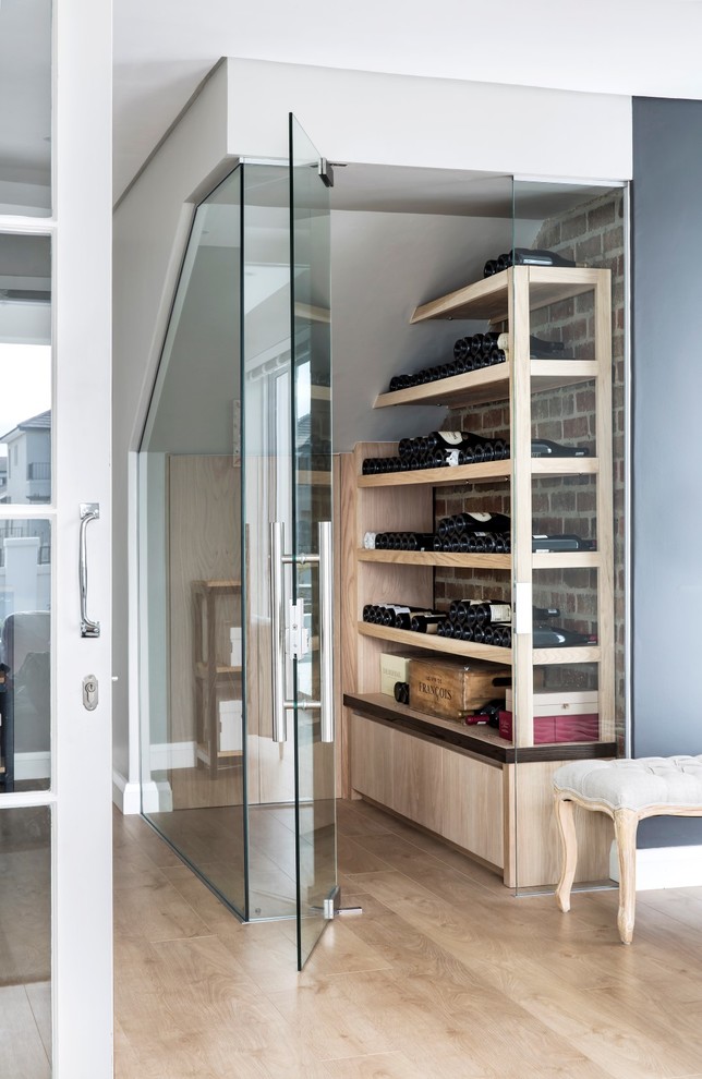 Design ideas for a small classic wine cellar in Other with laminate floors and display racks.