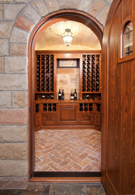 Design ideas for a medium sized rural wine cellar in Other with brick flooring and display racks.