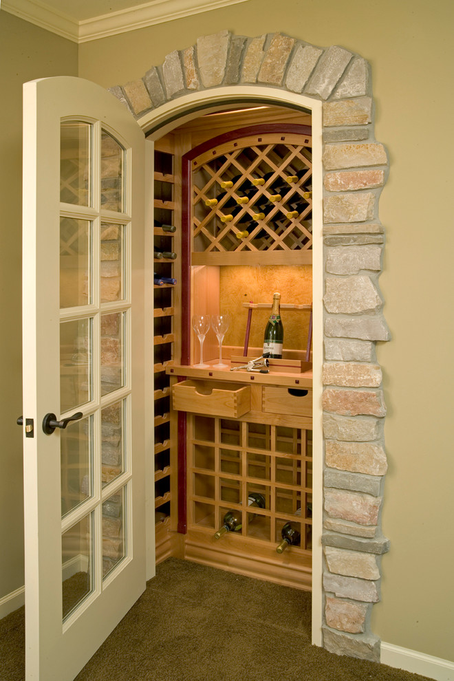 Design ideas for a small traditional wine cellar in Minneapolis with carpet and storage racks.