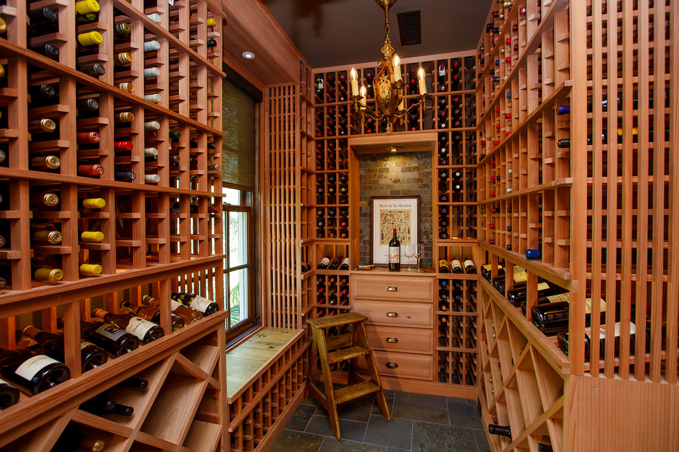 Beach style wine cellar in Other with storage racks and grey floors.