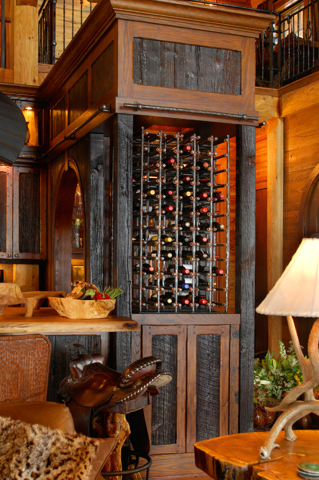 Example of a mid-sized mountain style medium tone wood floor wine cellar design in Charlotte with display racks