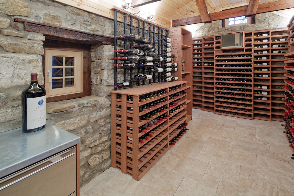 Inspiration for an expansive rustic wine cellar in New York with travertine flooring, storage racks and beige floors.