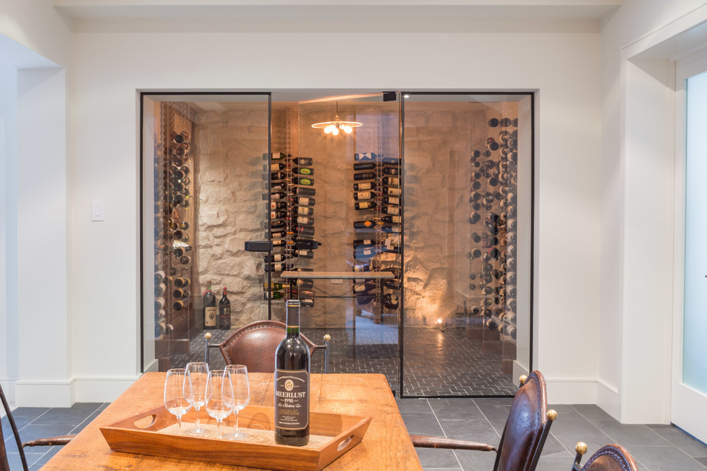 Inspiration for a medium sized traditional wine cellar in Toronto with slate flooring, display racks and grey floors.
