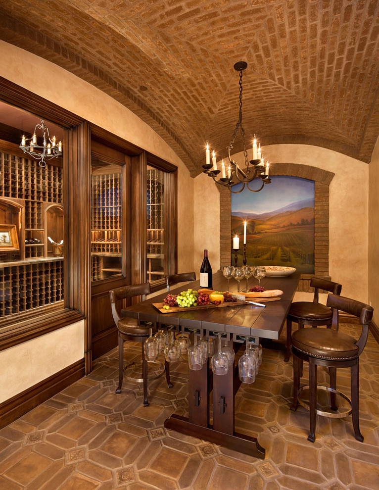 This is an example of a large rustic wine cellar in San Francisco with ceramic flooring and storage racks.