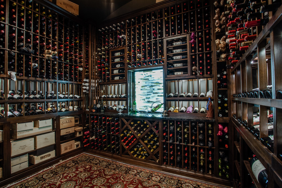 Medium sized traditional wine cellar in Dallas with storage racks and dark hardwood flooring.