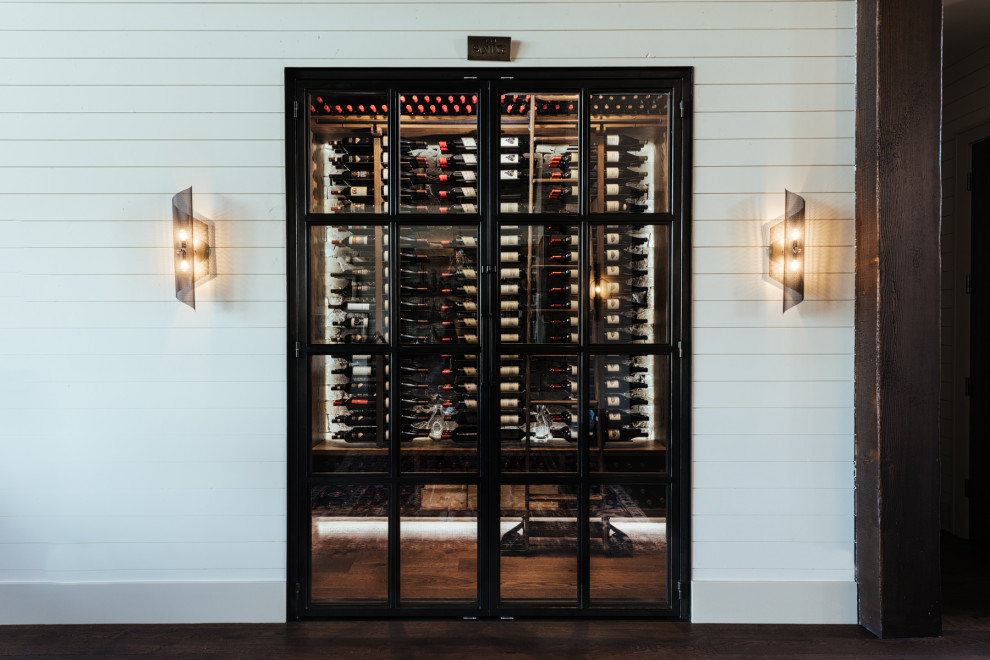 Inspiration for a medium sized contemporary wine cellar in Portland with dark hardwood flooring, storage racks and brown floors.