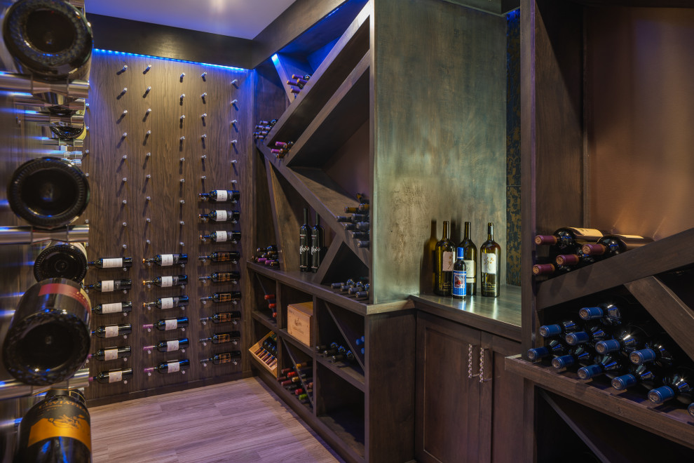 Contemporary wine cellar in Cincinnati with display racks and brown floors.