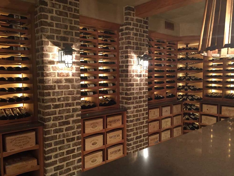 Photo of a large classic wine cellar in Other with travertine flooring and display racks.