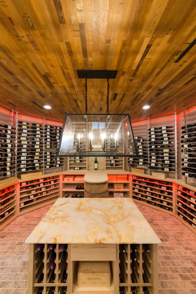 Inspiration for a large transitional brick floor and gray floor wine cellar remodel in New York with display racks