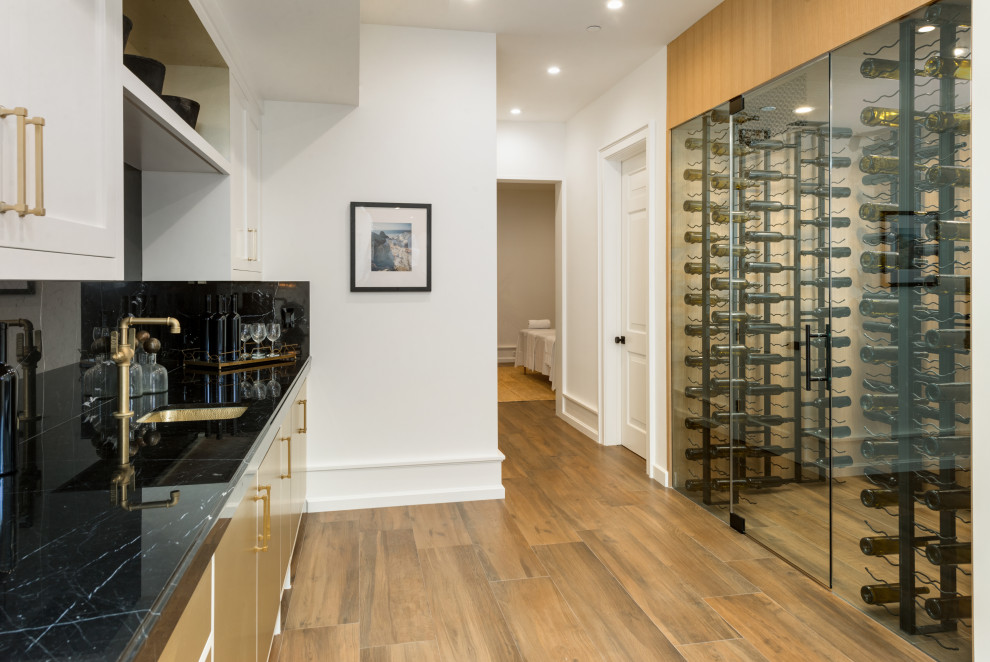 This is an example of a medium sized contemporary wine cellar in Los Angeles with display racks.