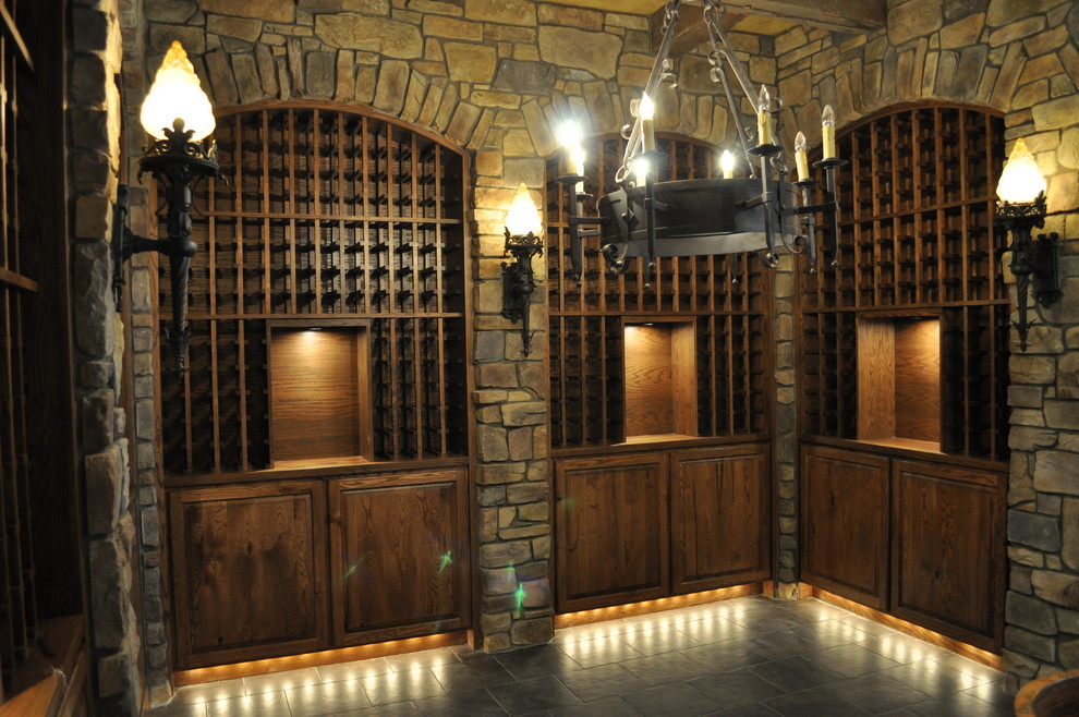 Wine cellar - large mediterranean gray floor wine cellar idea in Portland with storage racks