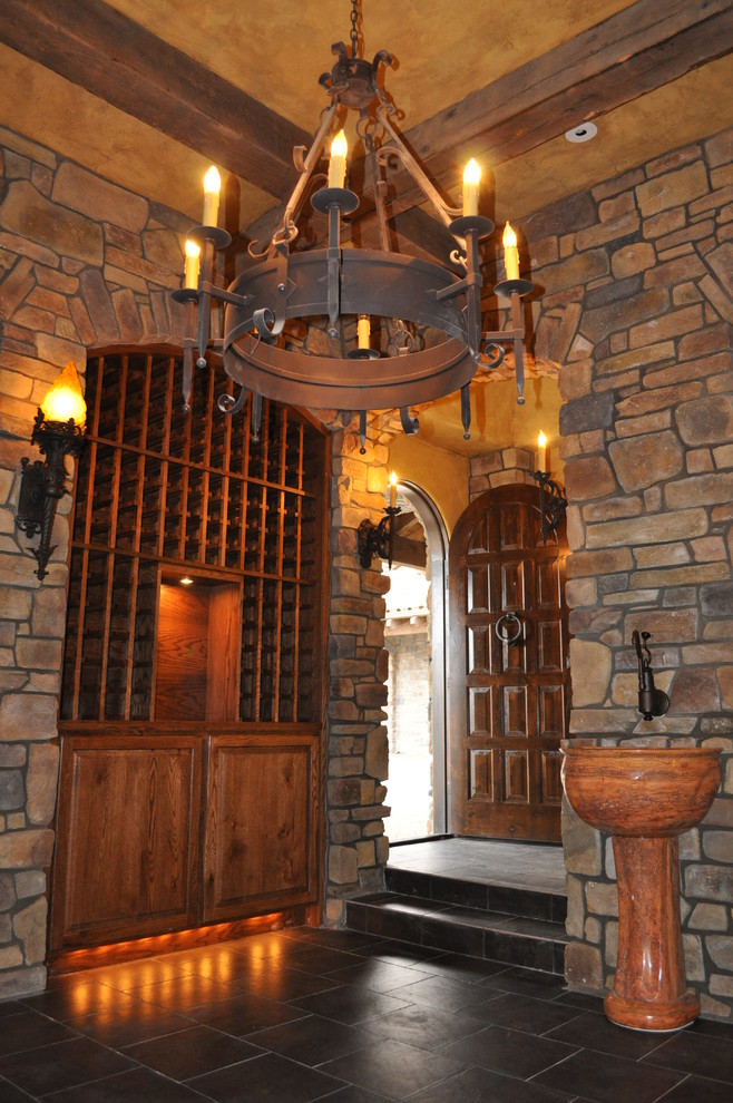 Example of a large tuscan gray floor wine cellar design in Portland with storage racks