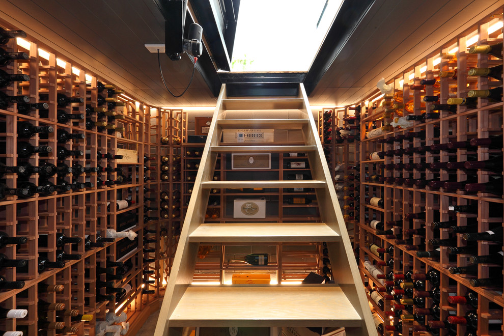 Example of a small trendy wine cellar design in Auckland with storage racks