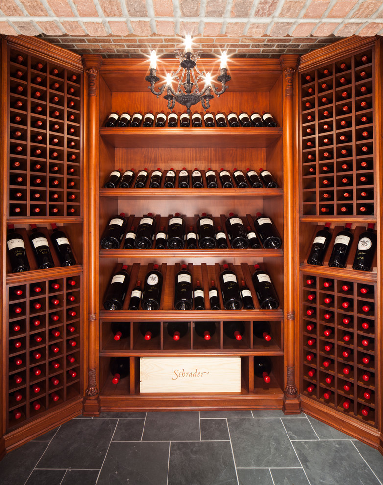 Inspiration for an expansive traditional wine cellar in New York with display racks and grey floors.
