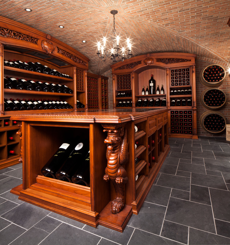 This is an example of an expansive classic wine cellar in New York with display racks and grey floors.